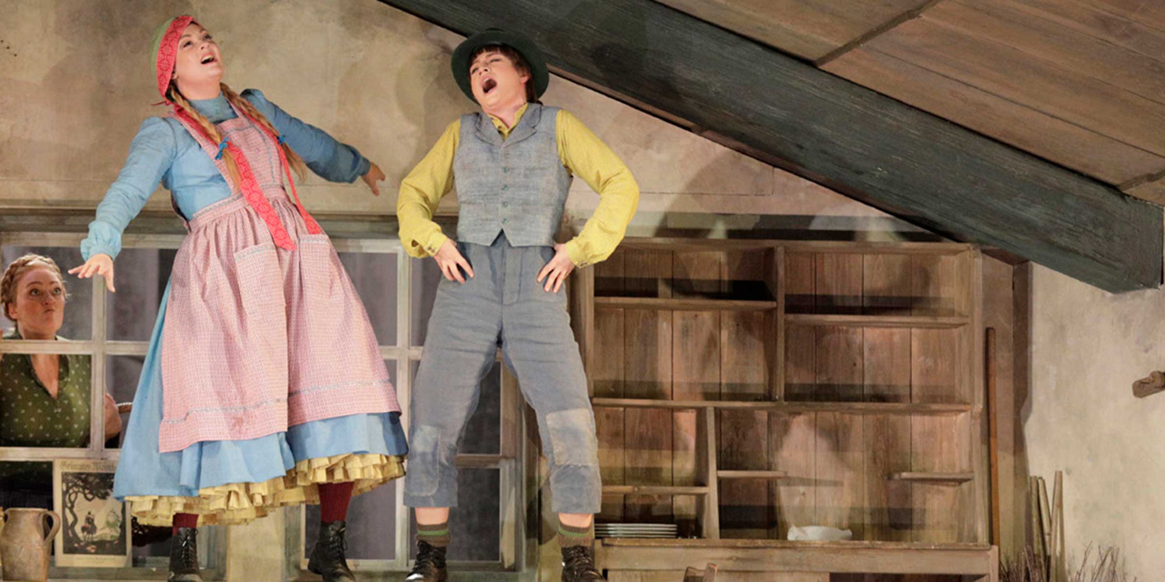 Cast members standing on table dancing